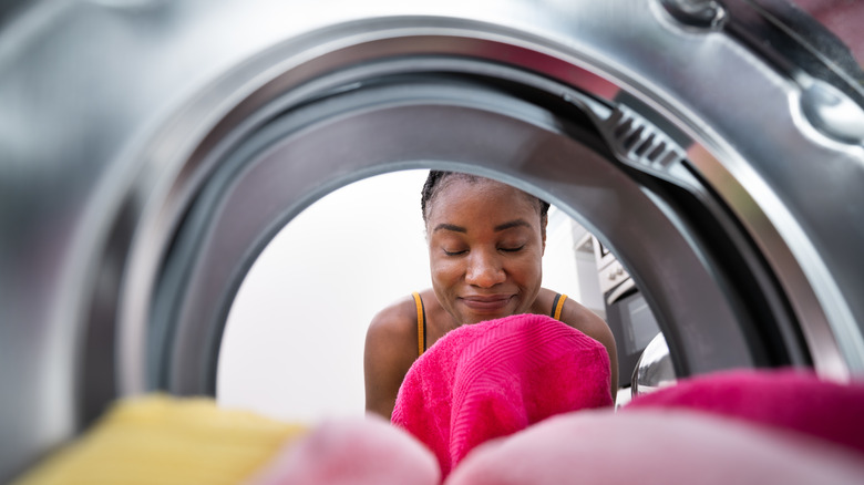 woman looking inside washer 