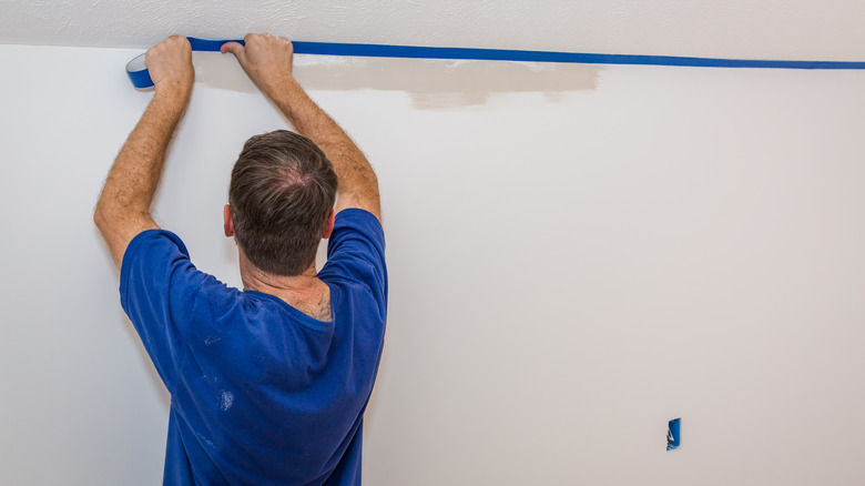 man applying painter's tape