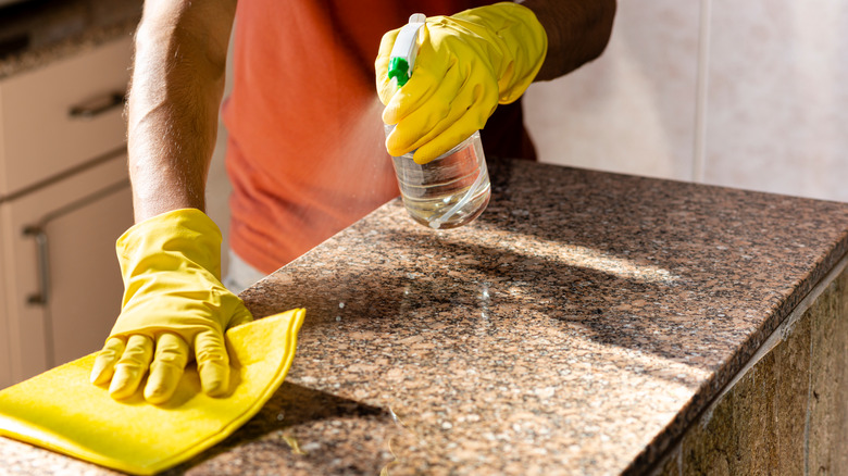 Person spraying granite countertops