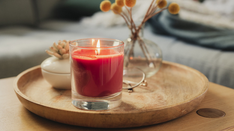 Lit candle on table