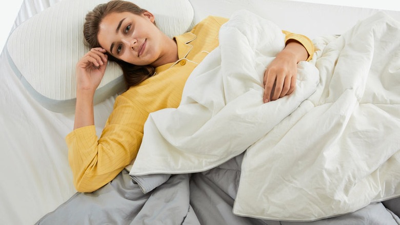 Woman on silk-filled duvet