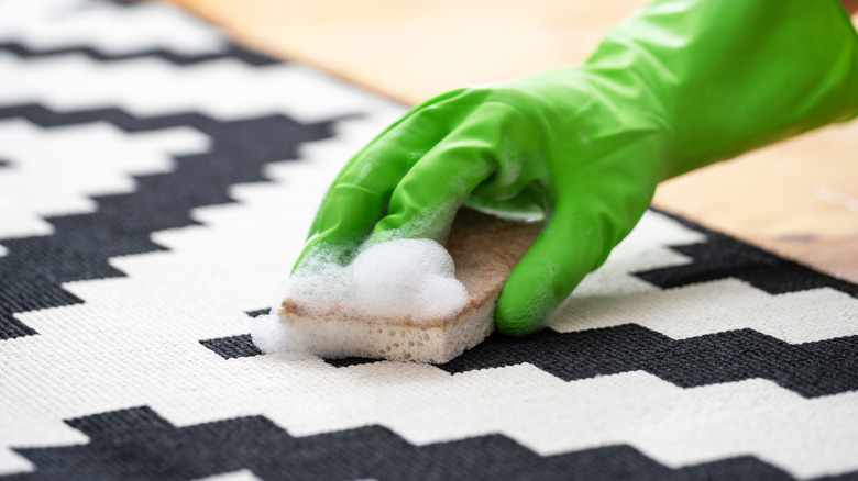 Person scrubbing carpet