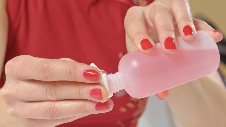 person using super glue to fix a broken mug