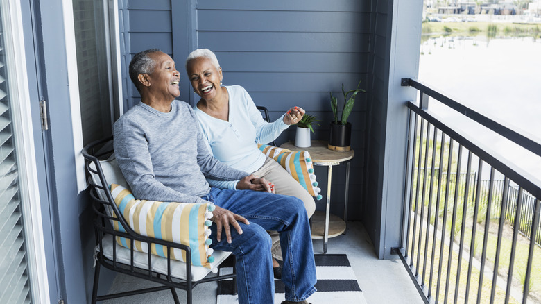 happy couple sitting on porch