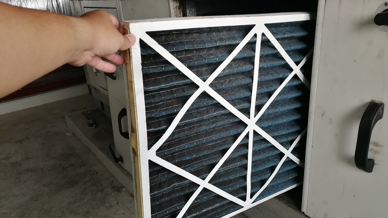 man changing HVAC filter