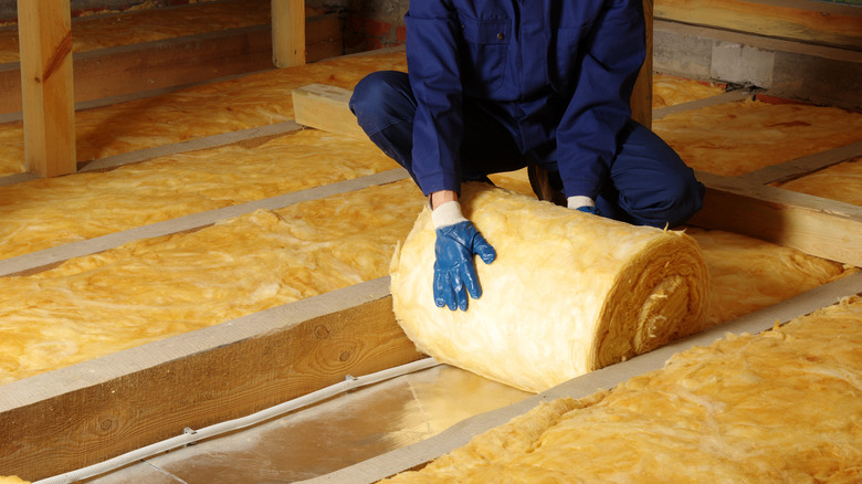 man installing insulation 