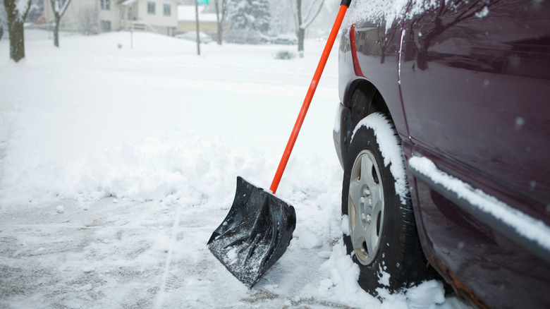 snow shovel and car