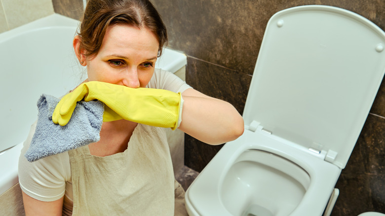 woman in front of smelly toilet