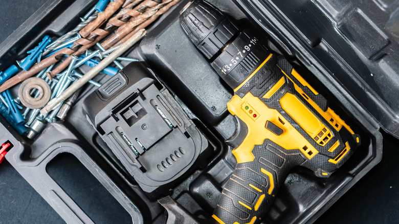 Cordless drill stored in plastic case with charger