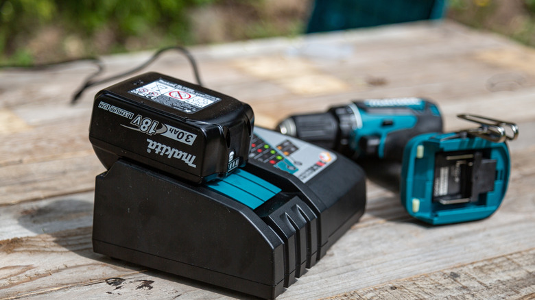 Cordless drill battery charging on a dock