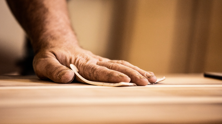 Man using sandpaper