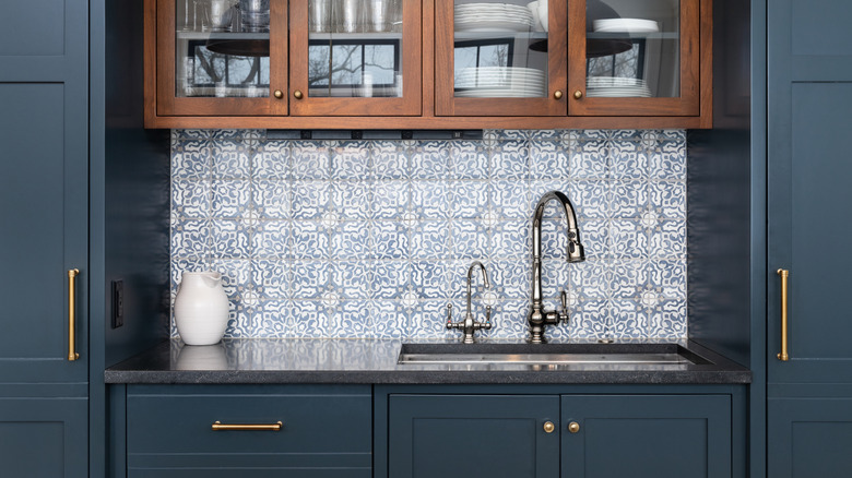 Kitchen with brass hardware and chrome sink