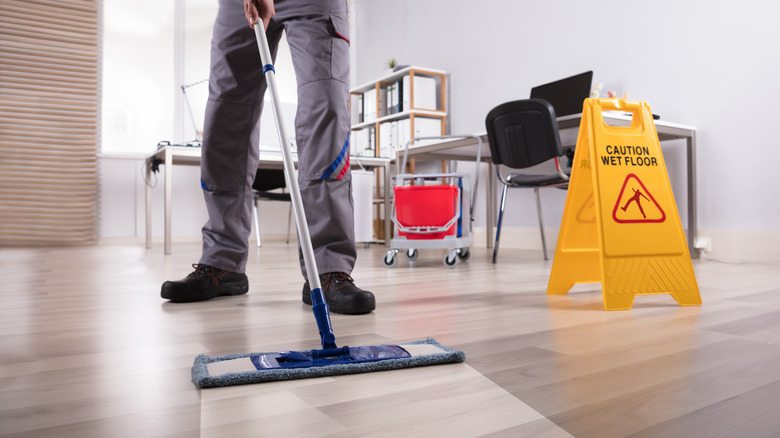 Person mopping wood floor