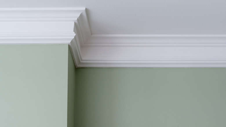 A room with green walls and white trim