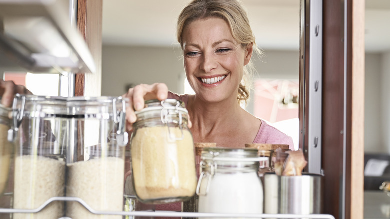 Woman pulling jar from vertical drawer