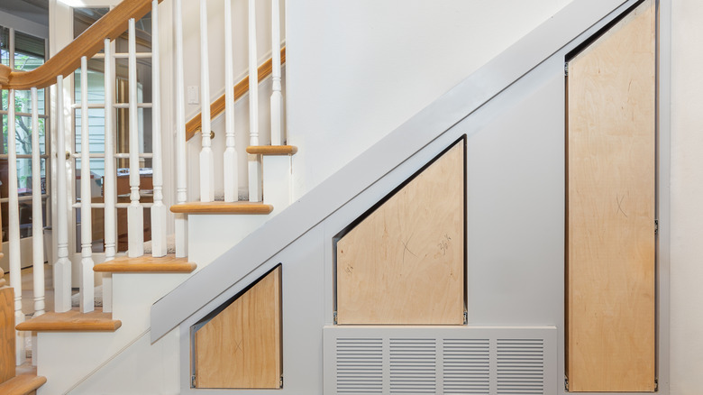 Pull out vertical drawers under stairs