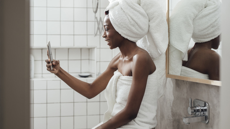 woman taking selfie in bathroom