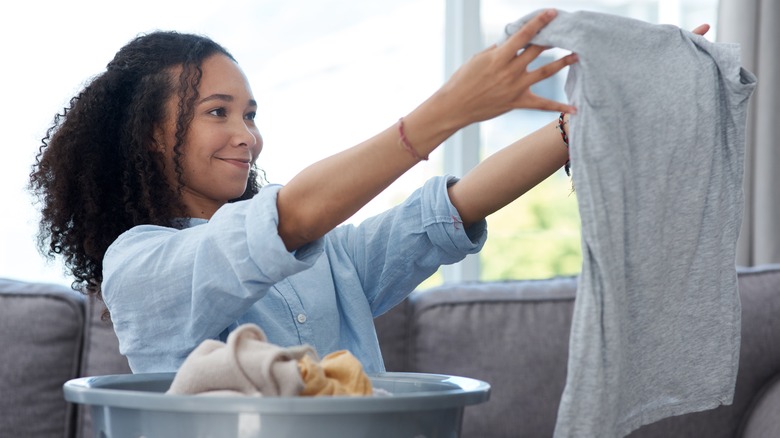 woman holding up clean shirt