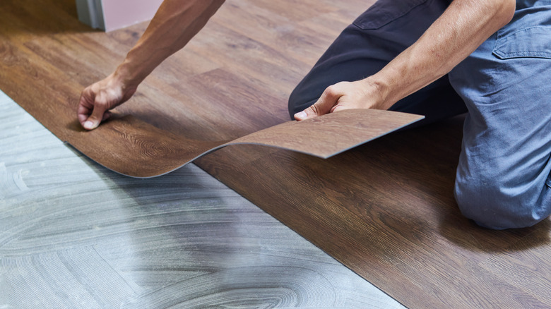 Man installing vinyl flooring