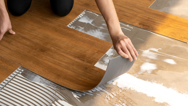 Person installing vinyl flooring