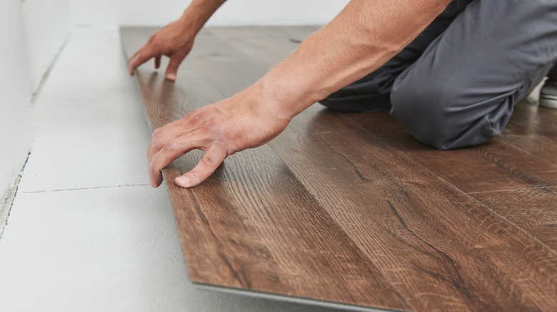 Person laying laminate flooring