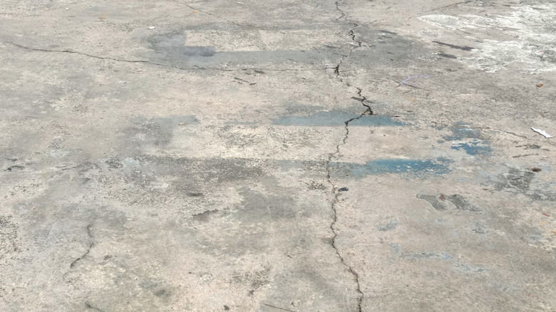 A tired and cracked garage floor in need of a new finish