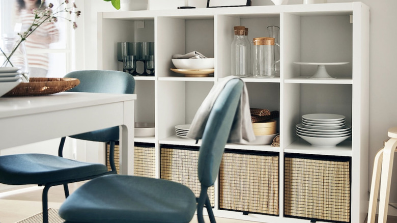 An IKEA KALLAX cubby storage unit in a blue and white kitchen