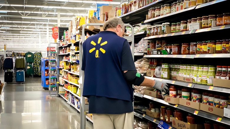 Walmart employee restocking shelves