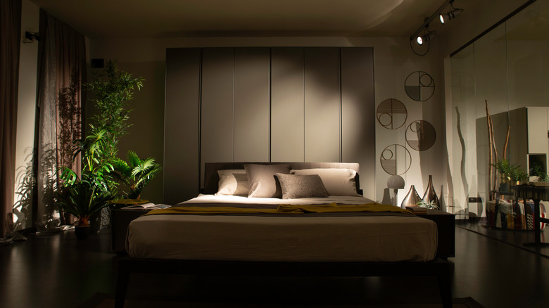 Dim luxurious bedroom with plants