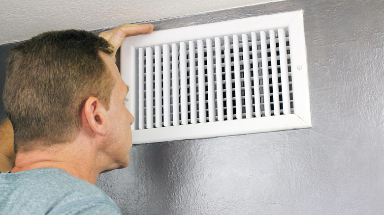 Person looking in a vent