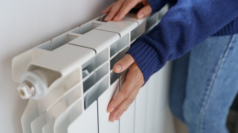 Woman with hands on radiator