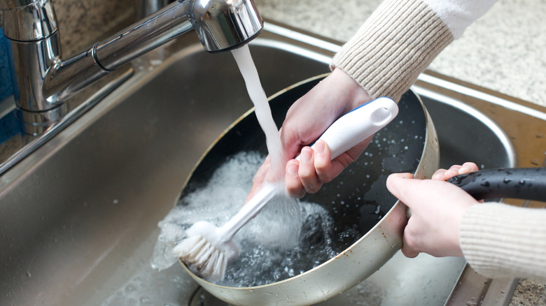 Person scrubbing a non-stick pan