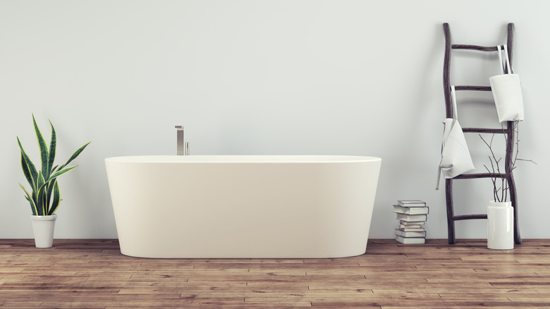 hardwood bathroom floor with tub