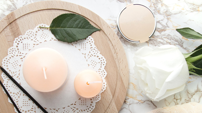 dainty candles on a cork board