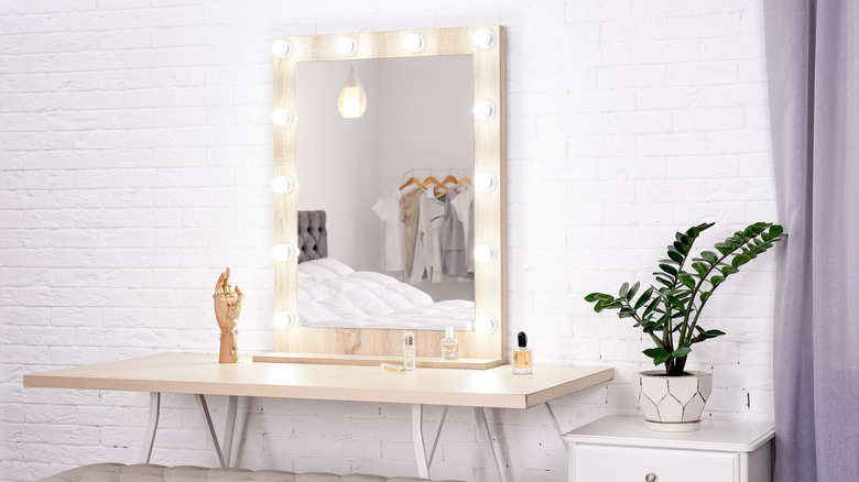 vanity with bulbs around the mirror 