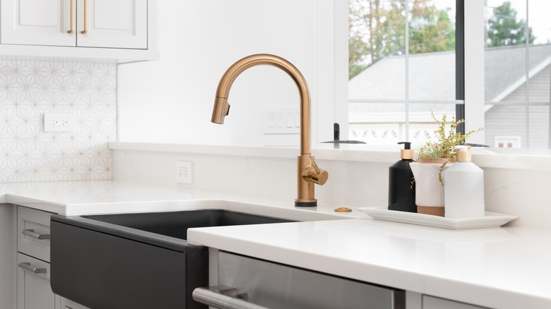 gold finish faucet in kitchen