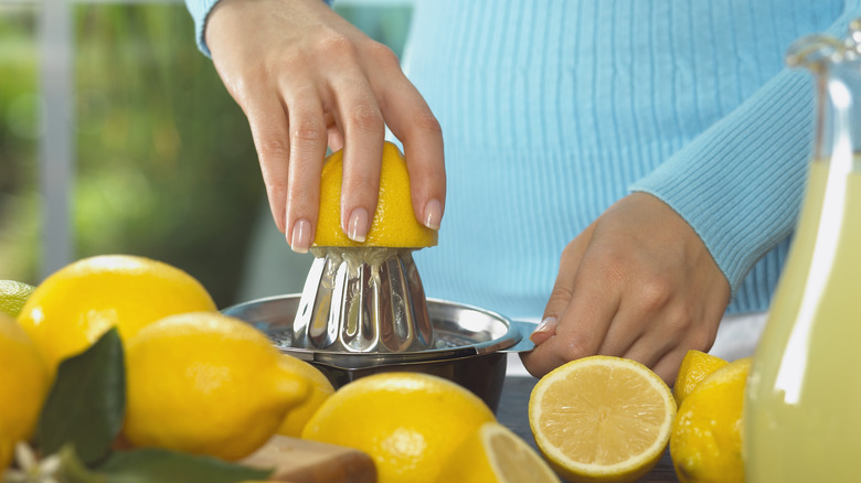 person juicing lemon