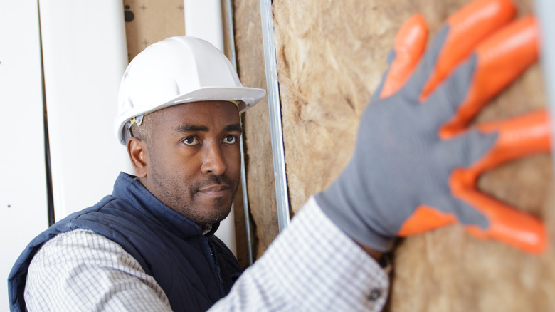 Man installing rockwood panel