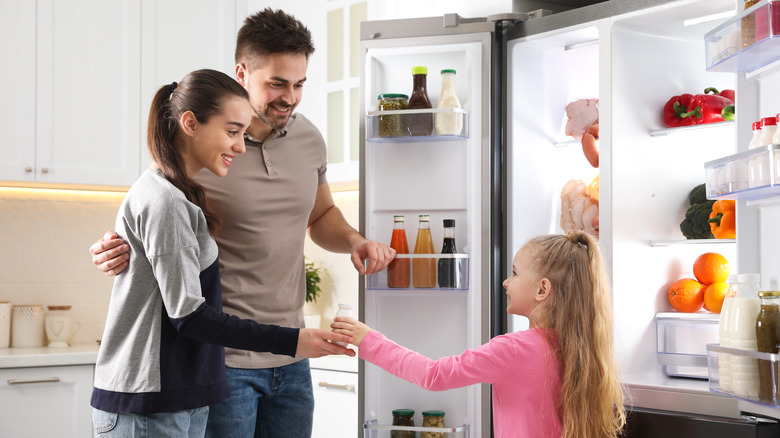 family near refrigerator 