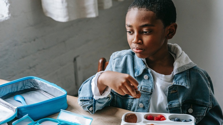 boy eating packed lunch 