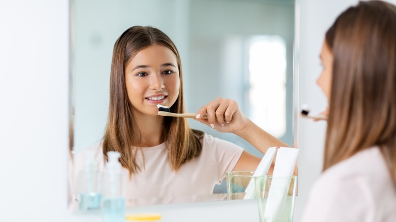 girl brushing her teeth 