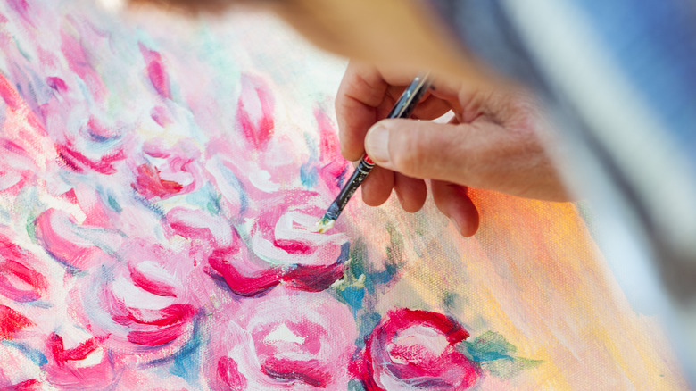 woman painting bouquet