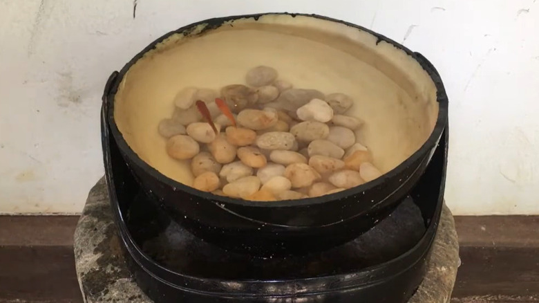 two fish swimming in a bowl made from an old motorcycle helmet