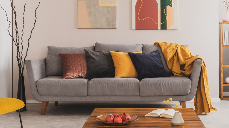 grey couch with colorful cushions