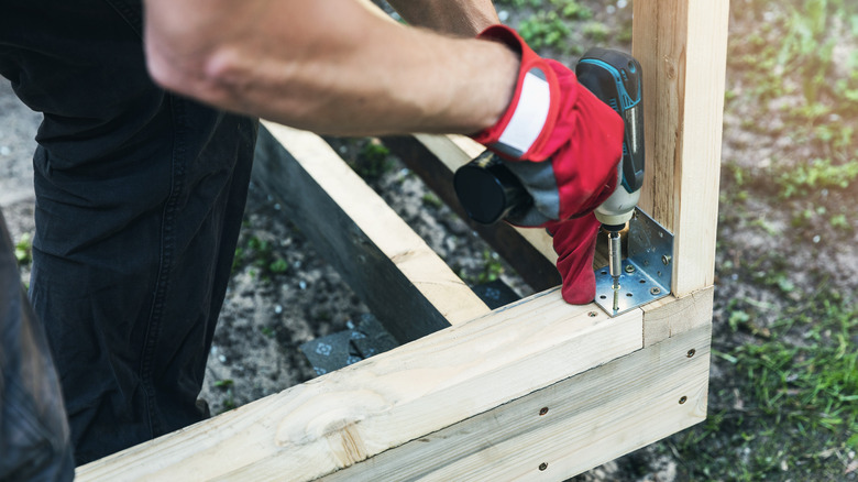 person working on shed build