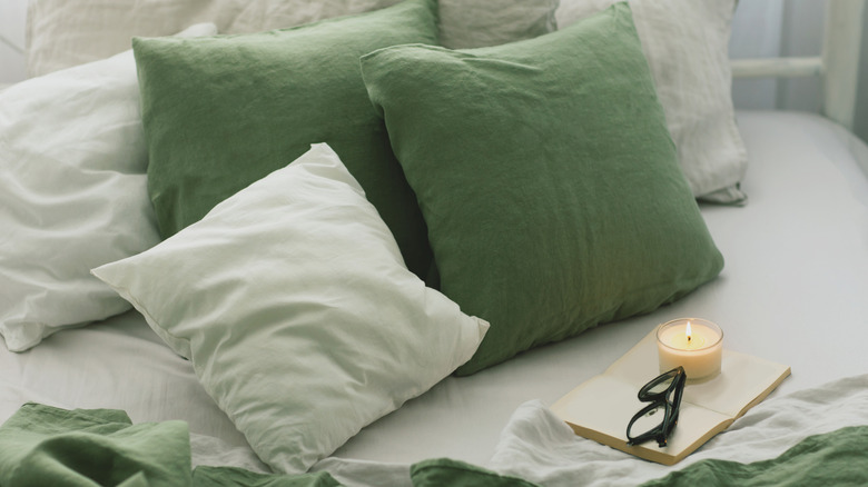 A close-up of a comfortable bed with throw pillows and sheets