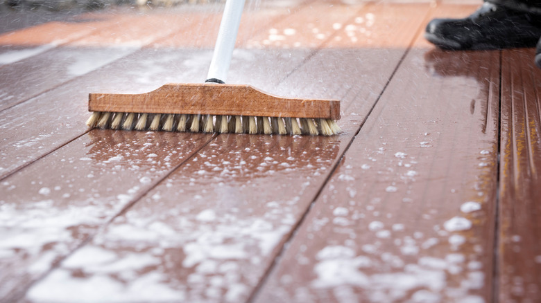 scrubbing wooden deck