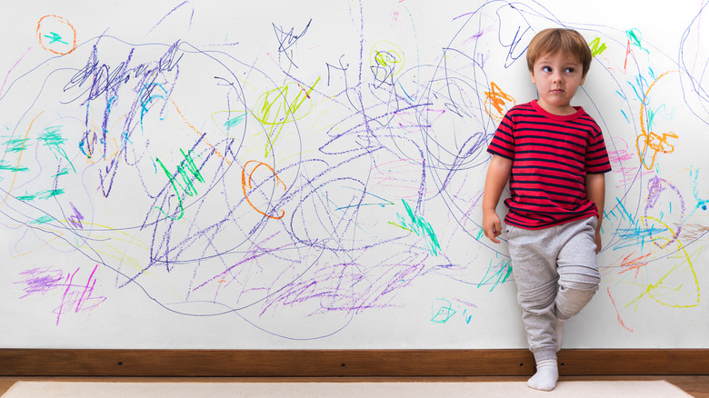 A kid with drawn-on wall