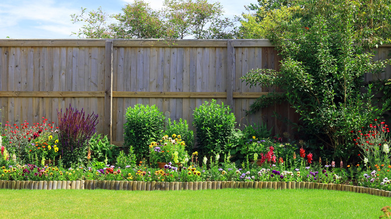 yard with fence and flower beds