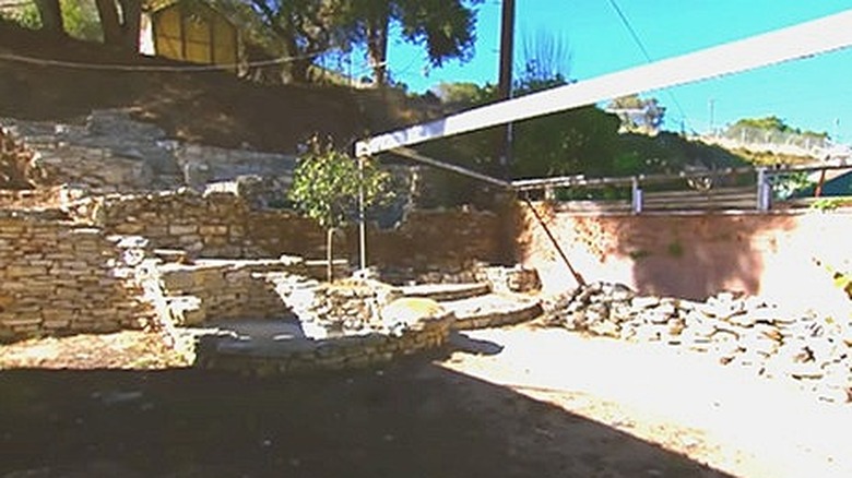 Stone wall slope with shed